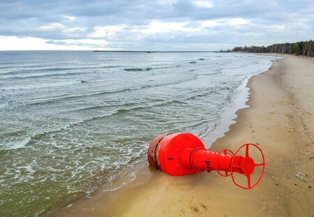 Red buoy on the Polish beach - landscape after stormの写真素材
