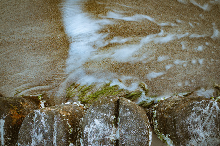 Sea currents beside dormant wooden planksの写真素材