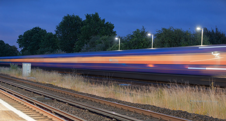 Train speeding through a UK station