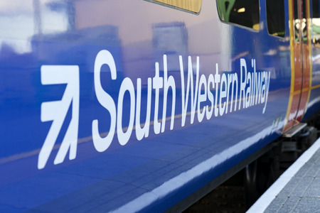 Alton, UK. 13th March 2018. Class 450 Desiro in SWT livery but partially re-branded in South Western Railway logos in Alton station at the end of the Alton Branch Line which serves London Waterloo.のeditorial素材