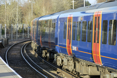 Alton, UK. 13th March 2018. Class 450 Desiro in SWT livery but partially re-branded in South Western Railway logos in Alton station at the end of the Alton Branch Line which serves London Waterloo.のeditorial素材