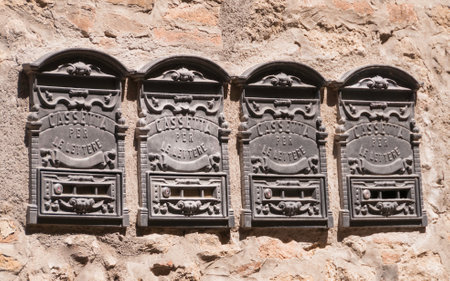 Four aged metal mailboxes in Volterra waiting for deliveryのeditorial素材