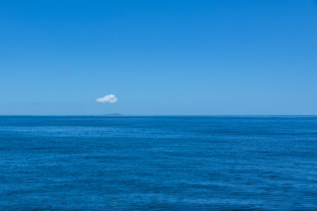 Small Cloud Over Small Frigate Island In The Indian Ocean, Seychellesの写真素材