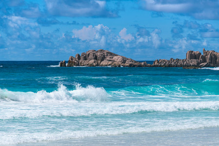 Beautiful Surf At Grand Anse On La Digue Island On A Sunny Dayの写真素材