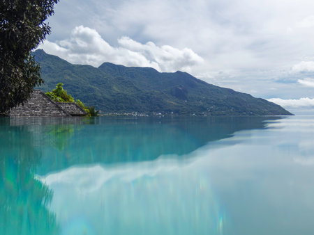 Relaxing In The Infinity Pool With A Nice View To The Mountains Of Mahe Island, Seychellesの写真素材