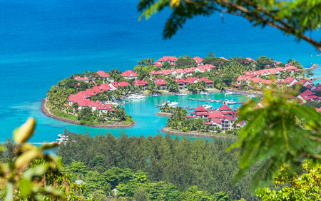 View of an artificial peninsula with residential buildings and a marina surrounded by blue watersの写真素材