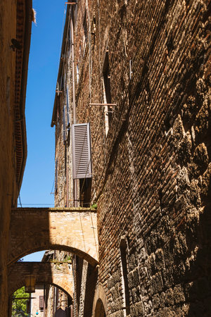 Narrow Shaddy Alley In San Gimignano In Tuscany, Italyの写真素材