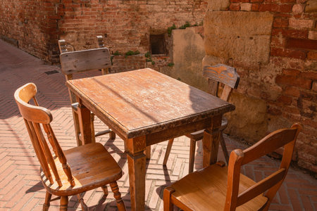 A Vintage Table And Four Chairs On A Street In Ancient Certaldo, Tuscanyの写真素材