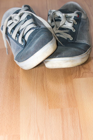blue shoes on wooden planked floorの写真素材