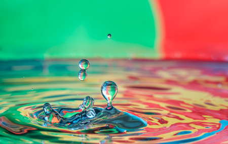 close up of colorful water droplets fallingの写真素材