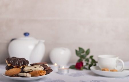 variation of cookies on a coffee table with a cup and coffee potの写真素材