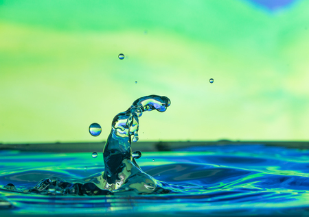 blue water droplets with a green backgroundの写真素材