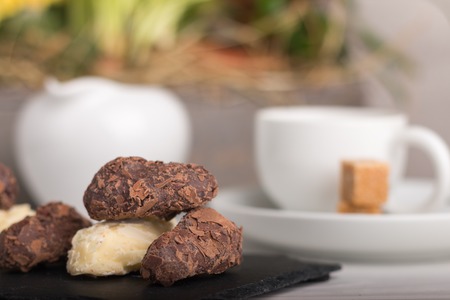 homemade variety of chocolate truffles on a plate with coffee.の写真素材