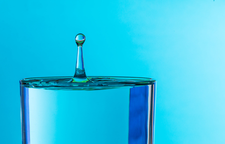 water drop splash in a glass of drinking waterの写真素材
