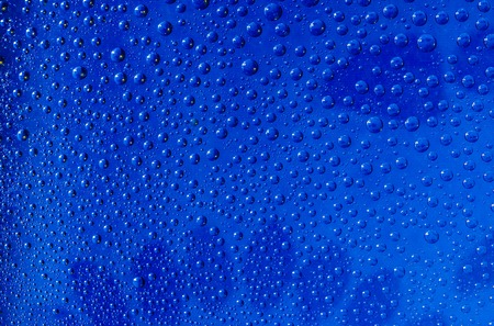 water drops on a glass surface blue