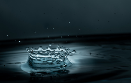 water drop splash impact on a water surface black and white close upの写真素材