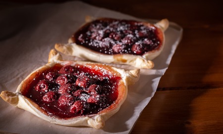 Homemade cherry pie in a spot light on a dark wooden backgroundの写真素材