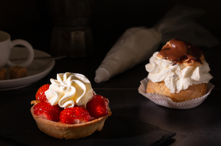 sweet homemade strawberry pie dessert with whipped cream on a kitchen table with coffee