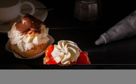 sweet homemade strawberry pie dessert with whipped cream on a kitchen table with coffee