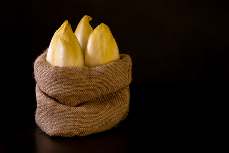 Raw organic Belgian endives in a bag.の写真素材