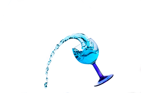 Blue water splash in a glass isolated on a whiteの写真素材