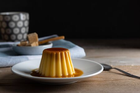 Homemade desert creme caramel pudding with a cup of coffeeの写真素材