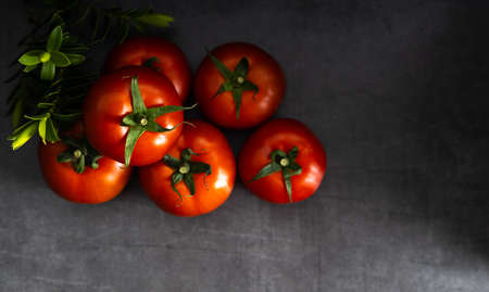 Fresh fruit, delicious tomato on a dark background with copy space. Top view.の写真素材