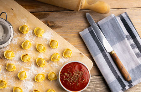 Homemade tortellini made with organic ingredients on a kitchen table. Top view.の写真素材