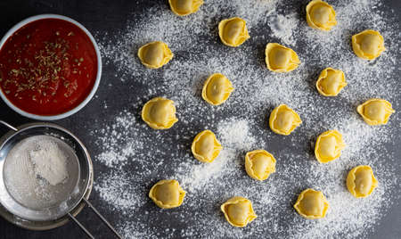 Homemade tortellini made with organic ingredients on a kitchen table. Top view.の写真素材
