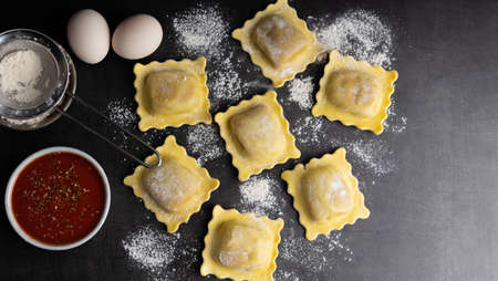 Homemade tortellini made with organic ingredients on a dark stone table. Top view.の写真素材
