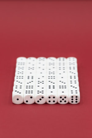 Many lined up cubes on a red background with copy space. High quality photo