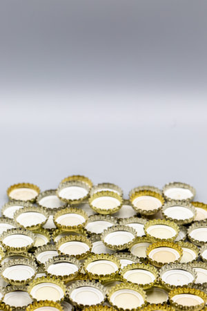 Background with bottle caps of soft drinks and beer with copy space. vertical