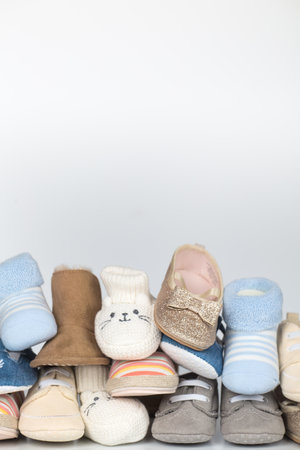 many newborn shoes in different colors with copy space above. verticalの写真素材