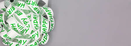 White gift ribbon knotted together with inscription happy birthday as background for web design, banner or card. Horizontal panoramaの写真素材