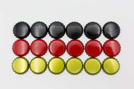 German flag made of crown corks of beer bottles in black, red and gold, symbolic for the German pleasure for beer. Horizontalの写真素材