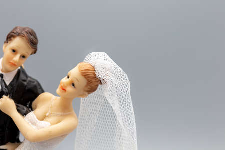 Figures of a wedding couple with bride and groom isolated with grey background for greeting cards or...