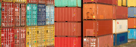 Frankfurt, Germany - 23.02.2021 - Stacked containers in various colors in harbor area for worldwide...