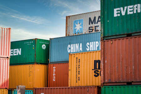Frankfurt, Germany - 02/23/2021 - Stacked containers in many colors in harbor area for worldwide transport. Horizontalのeditorial素材