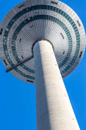 Frankfurt, Germany - February 21, 2021 - Europaturm photographed from the bottom of the city, during the day with blue sky in Frankfurt. Verticalのeditorial素材
