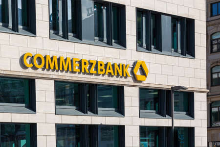 Commerzbank logo and lettering on a bank in Frankfurt, Germany on February 11th, 2021 with yellow colored words, editorially. Horizontalのeditorial素材