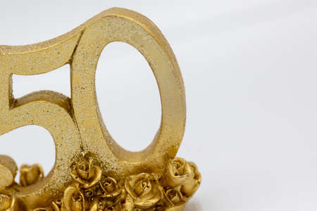 Fifty in golden color for golden wedding or anniversary, birthday on white background for greetin card or invitation. Horizontalの写真素材