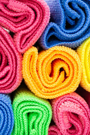 towels in different colors like blue, yellow, pink and orange for holiday, hotels, spa and hygiene as colored background. Verticalの写真素材