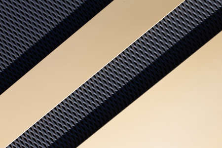 Abstract house facade with black and gold surfaces with sun reflection as background for architecture or art topics. Horizontalの写真素材