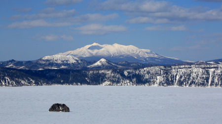 Volcanic lake and mountain in winterの写真素材
