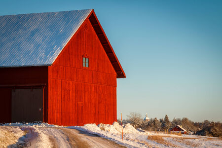 A red barn in winter sunlightの写真素材