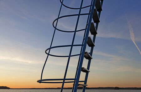 ladder to jumping tower in sunsetの写真素材