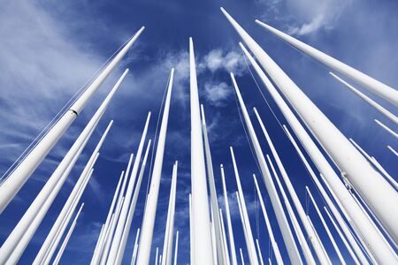 Umea, Sweden - July 25, 2019: lots of flagpoles after the Nolia fair in the fields near the fairgrounds with summer blue backgroundのeditorial素材