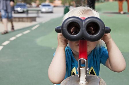 Umea, Sweden - July 29, 2019: a small spy with binoculars on the playground at Umedalenのeditorial素材