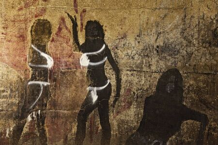 Umea, Sweden - August 22, 2019: old cave paintings destroyed by modern graffiti and spray paintのeditorial素材