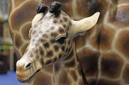 Umea, Sweden - June 29, 2019: plastic giraffe young next to mother giraffe at play land in Ersbodaのeditorial素材